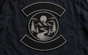 Original motorcycle-style back patch design on black denim vest